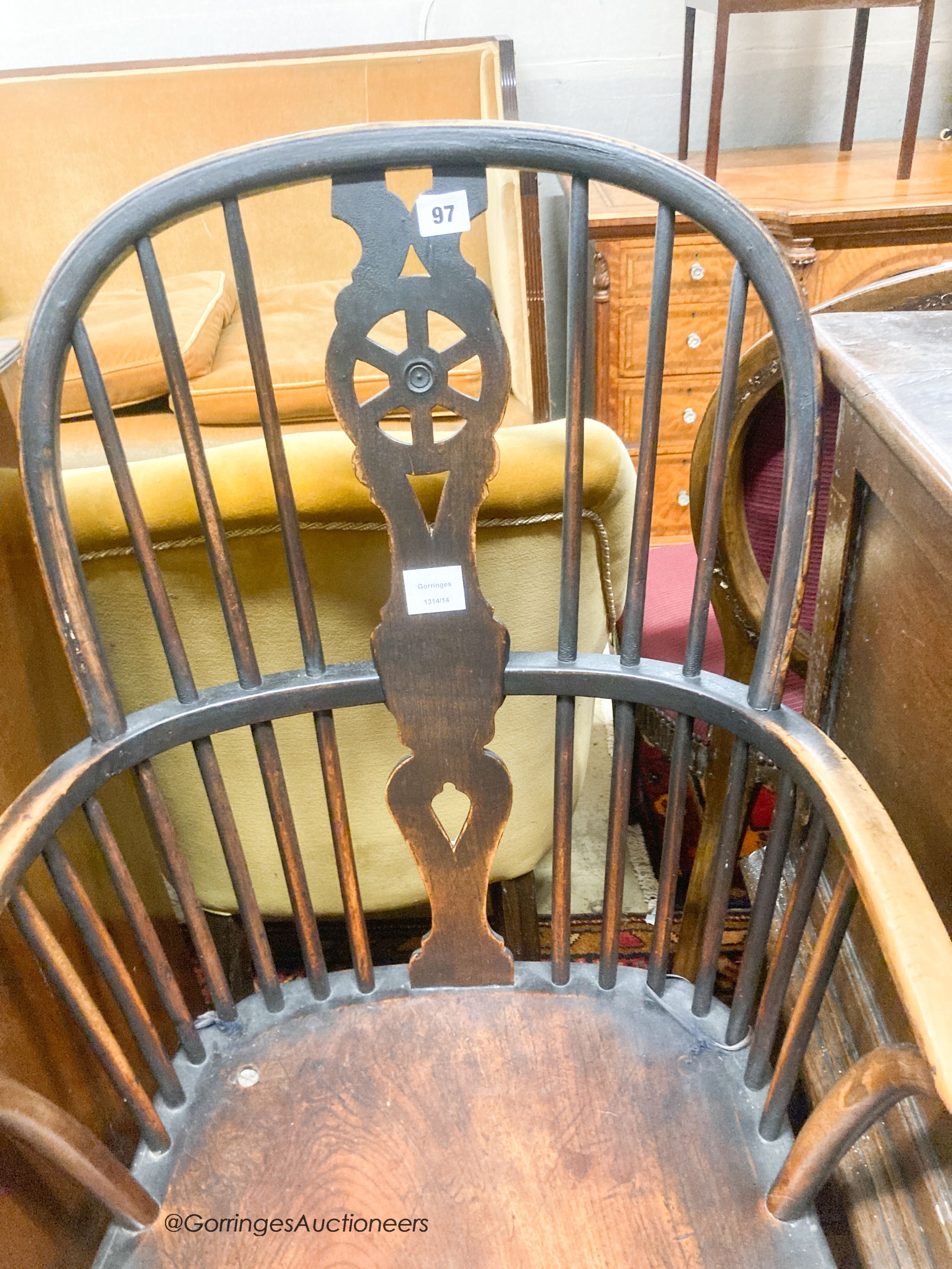 An early 19th century elm and ash wheel back elbow chair, width 52cm, depth 42cm, height 102cm